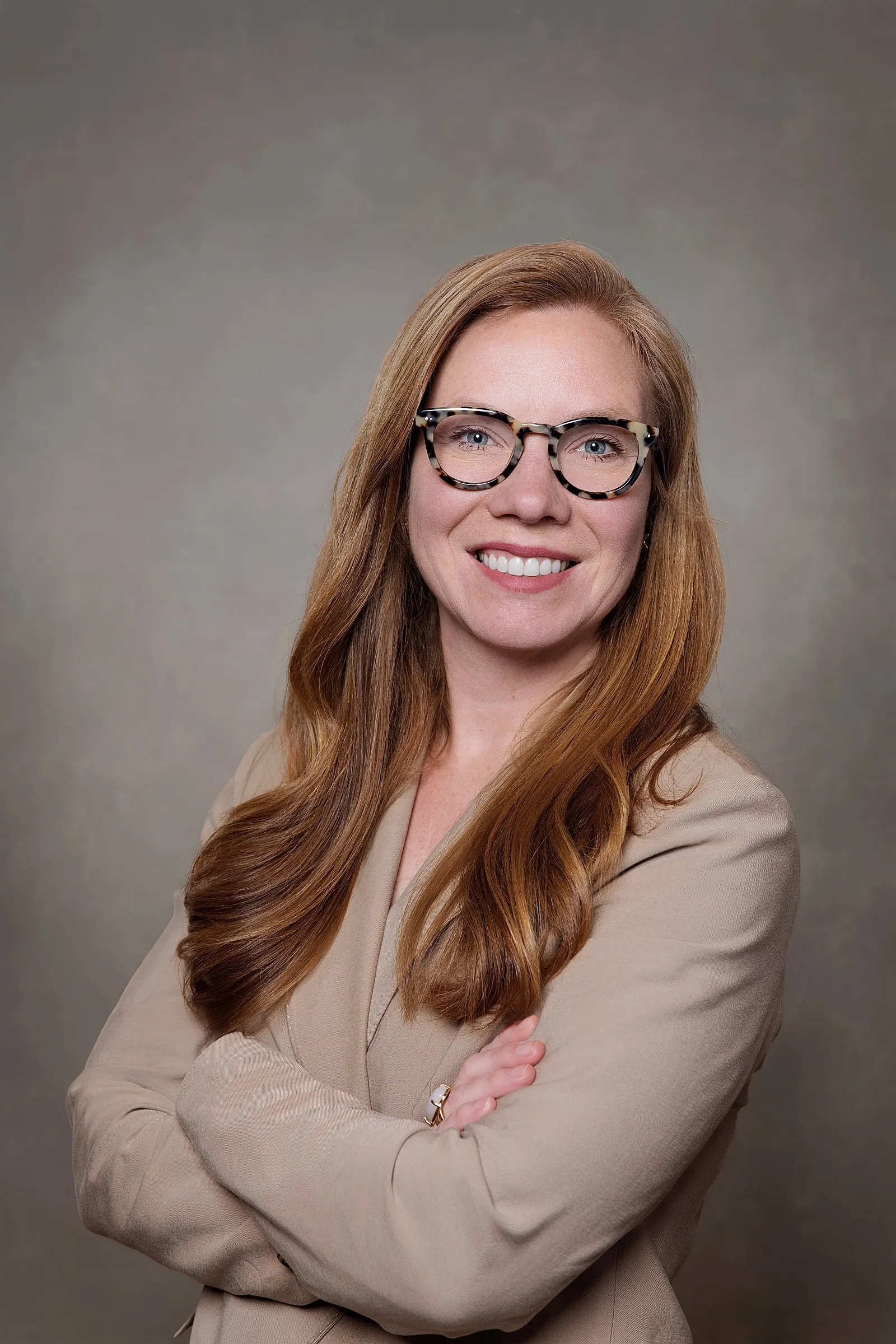Corporate headshot on a studio backdrop during a team session. Photo by Noomadik.